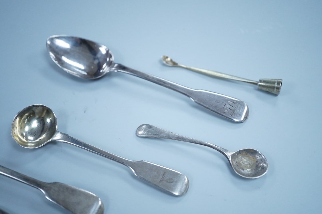 Two William IV silver fiddle pattern condiment spoons, both London 1831, a Victorian silver gilt ear wax spoon(lacking handle), two other silver spoons, a small white metal fork and a silver handled magnifying glass.